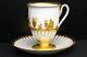 Antique Meissen Cup And Saucer With Gold Figures In Relief On White